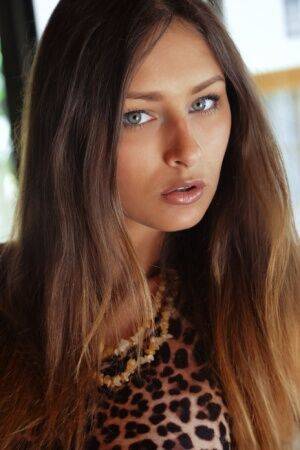Erotic teen Yarina A doffs her leopard skin dress & squats to spread her twat on picsofsex.com
