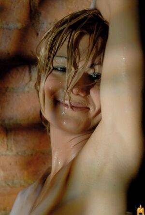 Glamour model gets soaking wet during a solo shoot afore a brick wall on picsofsex.com