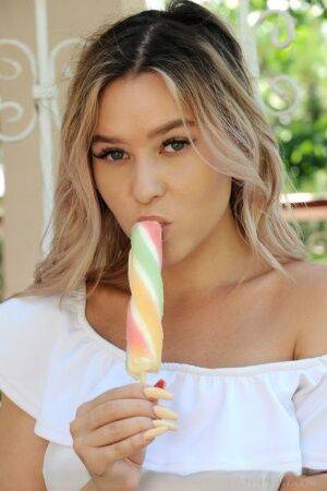 Dirty blonde teen Angelina Ash eats a frozen treat while getting totally naked on picsofsex.com