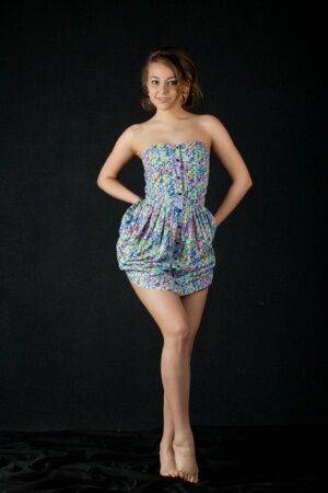 Beautiful young Nikia flashes a hot no panties upskirt before baring tiny tits on picsofsex.com