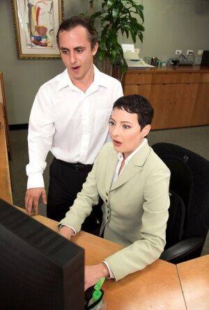 Short haired secretary Kali Karinena seduces a male coworker on picsofsex.com