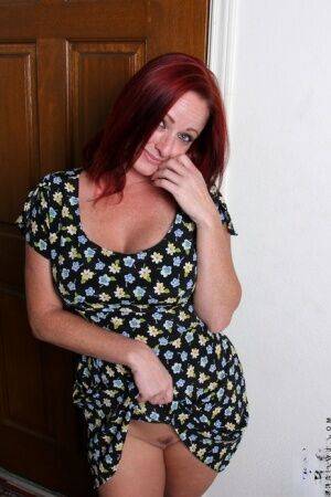 Redhead chick takes off her dress before toying her twat on a sofa in the nude on picsofsex.com