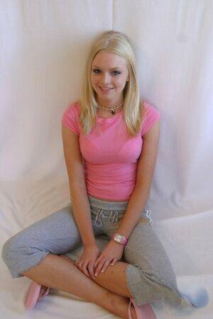 Cute teen girl Skye Model hangs out in a pink shirt and her yoga pants on picsofsex.com