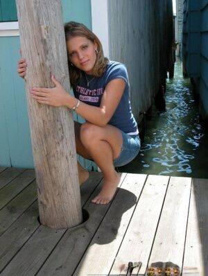 Cute young Karen squats on the pier to flash a hot cotton panty upskirt on picsofsex.com