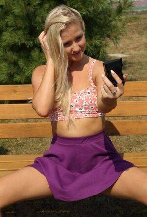 Amateur teen Cayla Lyons plays with her pussy on a park bench on picsofsex.com