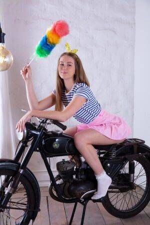 Adorable teen Milka gets totally naked in front of a vintage motorcycle on picsofsex.com