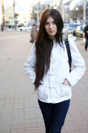 Beautiful teen Quillian walks clothed down a street after modeling in the nude on picsofsex.com