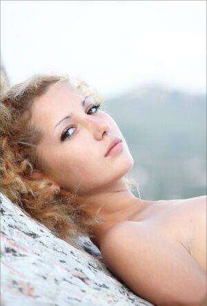 Small titted hot teen squats naked on a rock to show her shaved muff to all on picsofsex.com