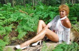 Mature redhead puts her great legs on display during a non-nude shoot on picsofsex.com