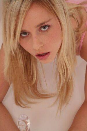 Hot blonde Kara Duhe on her knees shoving a glass dildo in her pretty face on picsofsex.com