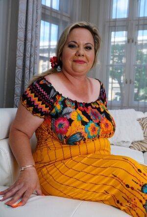 Obese older woman gets banged doggystyle on a sofa by her toy boy on picsofsex.com