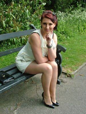 Thick woman in glasses shows off her stiletto heels on a park bench on picsofsex.com