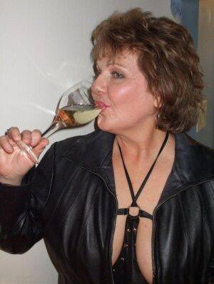 Mature amateur Busty Bliss sucks on her fingers while drinking too much wine on picsofsex.com