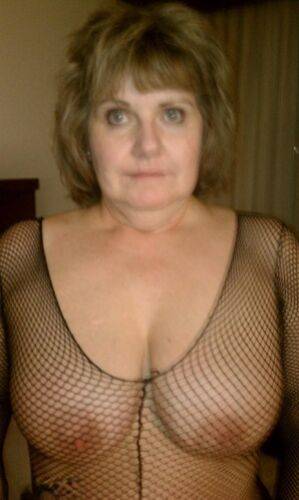 Mature amateur Busty Bliss delivers a POV blowjob in a mesh bodystocking on picsofsex.com