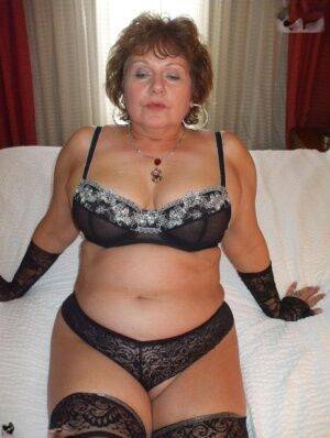 Plump older woman Busty Bliss flaunts her natural tits in arm socks and undies on picsofsex.com