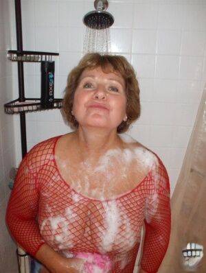 Older woman Busty Bliss soaps up her breasts before having her pussy licked on picsofsex.com