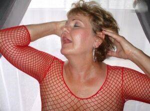 Mature lady Busty Bliss displays her big natural tits in a mesh dress on picsofsex.com