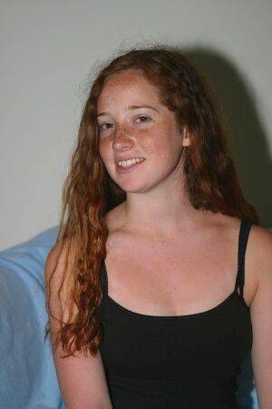 Young looking redhead Rachel puts her hairy vagina on display after undressing on picsofsex.com