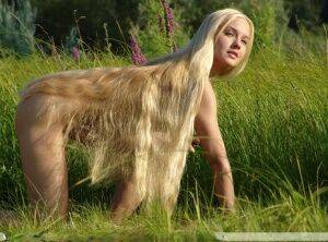 Natural blond with hair to her ass Desiree models totally naked amid greenery on picsofsex.com