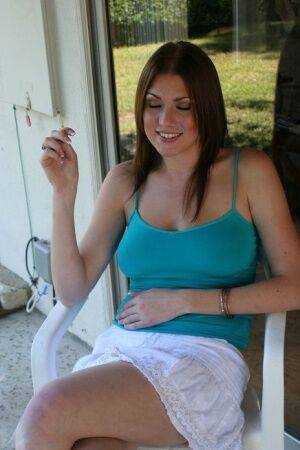 Barefoot chick Victoria Vonn smokes on the patio in a skirt and tank top on picsofsex.com