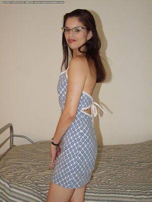 Geeky amateur Angelina removes her dress and glasses for her first nude poses on picsofsex.com