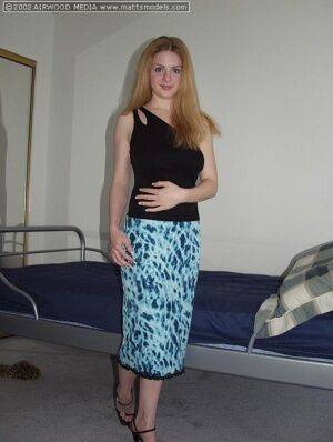 Amateur girl Heidi admires her big naturals in a mirror while getting naked on picsofsex.com