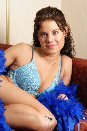 Brunette first timer Erin models non nude in elegant bra and blue feather boa on picsofsex.com