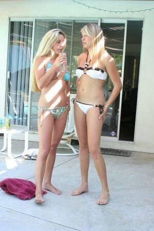 Blonde lesbians take up their bikinis to go naked in a swimming pool on picsofsex.com