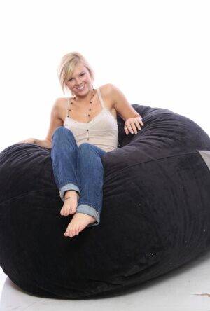 Blonde amateur models non nude on a bean bag chair in blue jeans on picsofsex.com