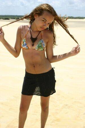 Latina teen Miranda Mirelli models in a bikini atop a sand dune on picsofsex.com