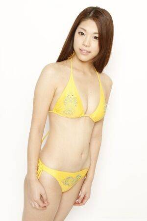 Young Japanese redhead models a yellow bikini in a safe for shoot - Japan on picsofsex.com