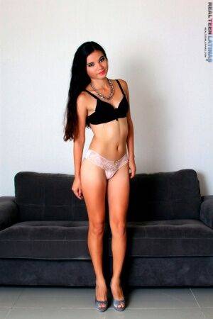 Latina teen Denisse models by herself in a bra and thong plus high heels on picsofsex.com