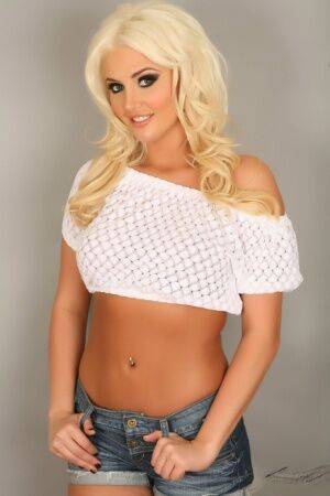 Platinum blonde beauty Kristina models non nude in a cropped top and shorts on picsofsex.com