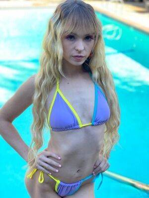 Blonde teen with long hair Lilly Bell models a bikini before a BJ and a facial on picsofsex.com