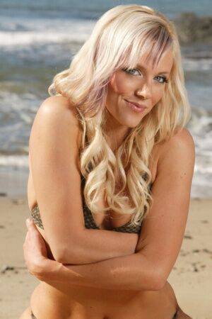 Blonde beauty Amy models on a sandy beach in her bikini on picsofsex.com