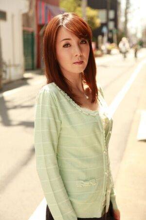 Japanese redhead Chika Sasaki models in a sweater and skirt in the road - Japan on picsofsex.com