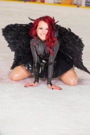 Redhead amateur Lara Larsen models non nude in latex attire with wings on picsofsex.com