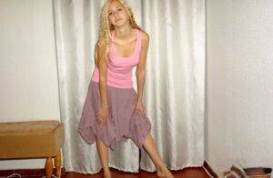 Clothed teen models in a skirt and tank top with curls put in her blonde hair on picsofsex.com