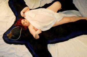 Fat redhead Black Widow AK models totally naked on a bearskin rug on picsofsex.com