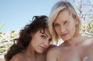 Glamour models Deni & Gabriela get atop each other while posing nude on sand on picsofsex.com