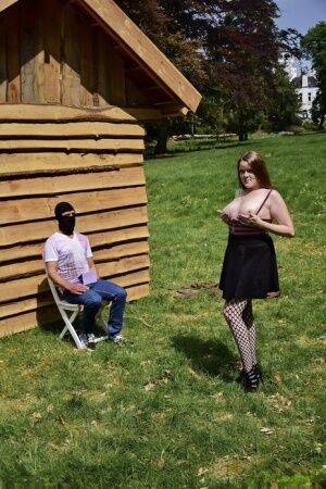 Natural redhead masturbates on a lawn before teasing a masked man on picsofsex.com