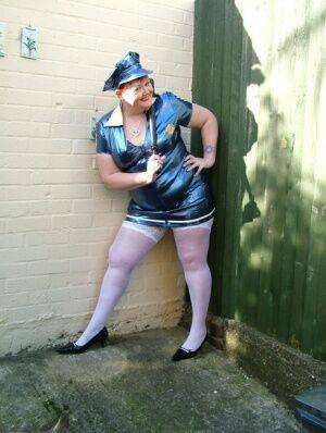 Mature plumper Valgasmic Exposed models latex police attire in white stockings on picsofsex.com