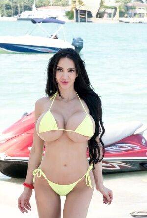 Hot curvy Amy Anderssen flaunts enormously round big tits on her jet ski on picsofsex.com