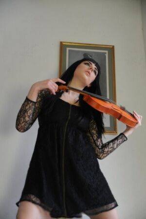 Dark haired violin player Sam Bentley strikes great poses while getting naked on picsofsex.com