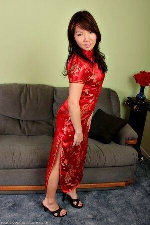 Amateur Asian babe strips off uniform to expose tiny teen breasts on picsofsex.com