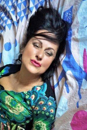Mature woman Diana Ananta showcases her vagina on top of her bed on picsofsex.com