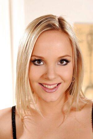 Smiley blonde teen with nice tits stripping and spreading her pussy lips on picsofsex.com