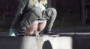 Caucasian girl Diana pisses on a sidewalk in a derelict environment on picsofsex.com