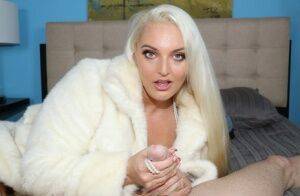 Platinum blonde chick Macy Cartel tugs on a dick while draped in a fur coat on picsofsex.com