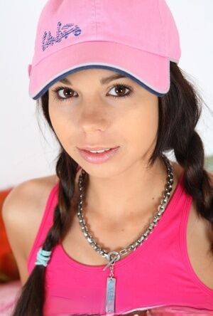 Cute teen Kiki 18 sports pigtails and a ballcap while having sex on a bed on picsofsex.com